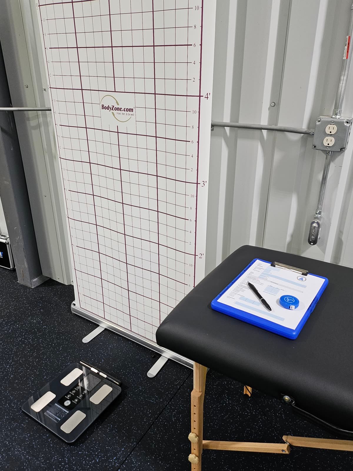 Activ8 assessment station with posture grid, body composition scale and assessment clipboard