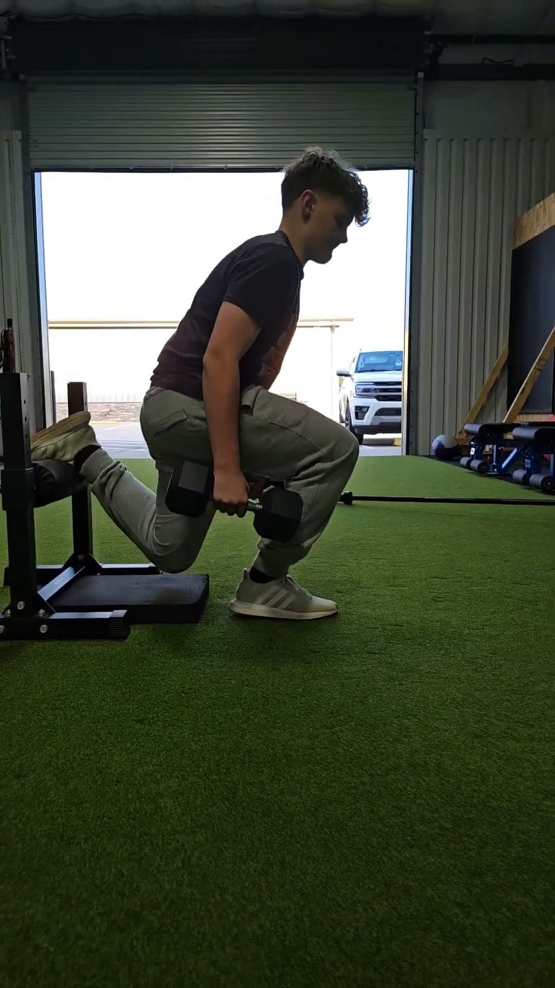 Coached rear-foot elevated split squat with dumbbells